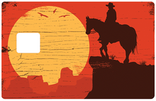 Load image into Gallery viewer, Cowboy au soleil couchant - Sticker pour carte bancaire, disponible en deux formats.